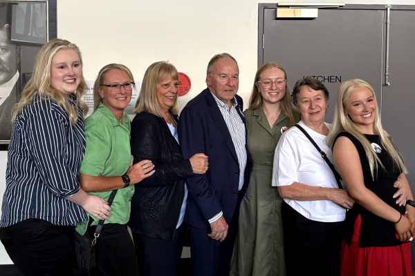 Robert Winther smiling with family at his 60 years of service event